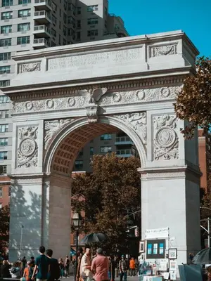 a large arch in a city with people walking around at Comfortable Apartment with Workstation in New York