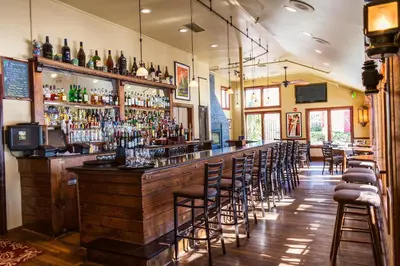 a bar with a lot of bar stools at Joseph Ambler Inn in North Wales