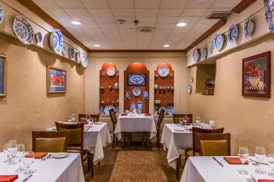 a restaurant with white tables and chairs and blue plates on the walls at Joseph Ambler Inn in North Wales