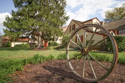 a large wooden wagon wheel in front of a house at Joseph Ambler Inn in North Wales