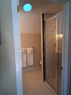 a bathroom with a shower and a toilet and towels at Joseph Ambler Inn in North Wales