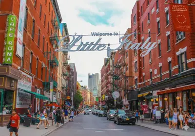 a busy city street with people walking down the street at Comfortable 2BR & 2 Bath Apt in Downtown NYC in New York