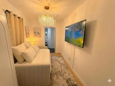a living room with a couch and a painting on the wall at Comfortable 2BR & 2 Bath Apt in Downtown NYC in New York