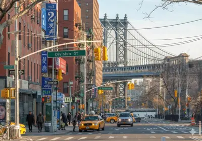 a busy city street with a bridge in the background at Comfortable 2BR & 2 Bath Apt in Downtown NYC in New York