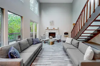 a living room with a couch and a fireplace at Brentwood Burrow in East Stroudsburg