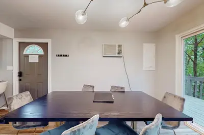 a dining room with a table and chairs at Brentwood Burrow in East Stroudsburg