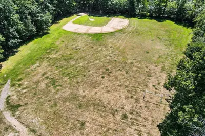 an aerial view of a large field with a park at Brentwood Burrow in East Stroudsburg