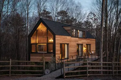 a tiny house in the woods at night at The Chatwal Lodge (All-Inclusive) - in The Unbound Collection by Hyatt in White Lake