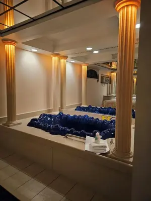 a row of blue pillows in a room with columns at Loop Inn Motel in Avenel