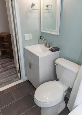 a bathroom with a white toilet and a sink at Stony Fork Inn in Wellsboro
