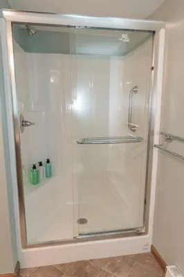 a shower with a glass door in a bathroom at Stony Fork Inn in Wellsboro