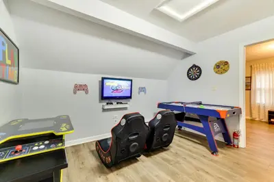 a room with a ping pong table and a tv at 5 Mi to Tobyhanna State Park Home with Game Room! in Tobyhanna
