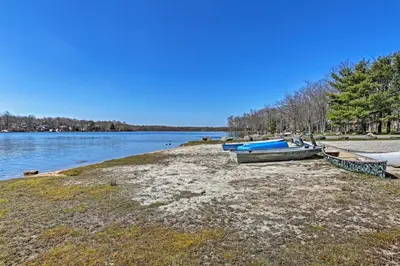 a group of boats on the shore of a lake at 5 Mi to Tobyhanna State Park Home with Game Room! in Tobyhanna
