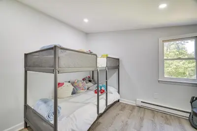 a bedroom with a bunk bed with white walls at Community Perks Family Poconos Home with Deck! in Tobyhanna