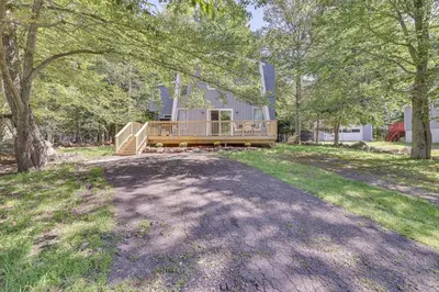 a home with a large yard with a house at Community Perks Family Poconos Home with Deck! in Tobyhanna