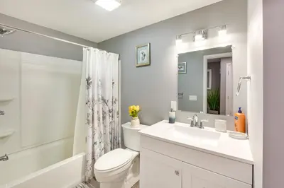 a white bathroom with a sink and a toilet at Mountville Rental with Private Patio and Gas Grill! in Mountville