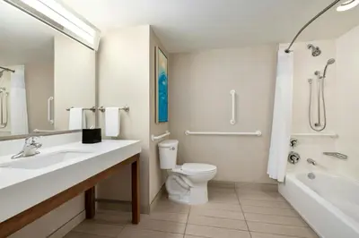 a bathroom with a sink and a toilet and a tub at Courtyard by Marriott Wilkes-Barre Arena in Wilkes-Barre
