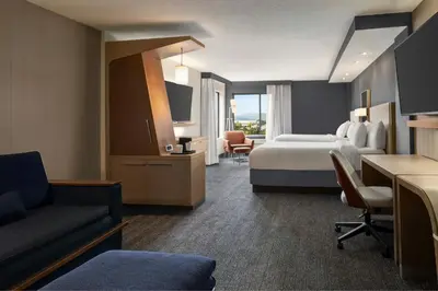 a hotel room with a bed and a couch at Courtyard by Marriott Wilkes-Barre Arena in Wilkes-Barre