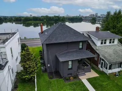 an aerial view of a house next to a river at Sunset Stay at 608 in Wormleysburg