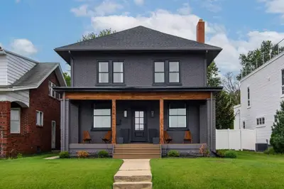 a gray house with a black front door at Sunset Stay at 608 in Wormleysburg