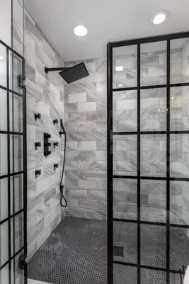 a shower with a glass door in a bathroom at Sunset Stay at 608 in Wormleysburg