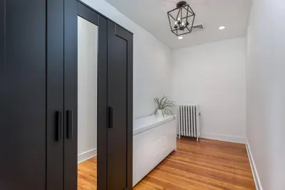 a room with a black door and a white wall at Sunset Stay at 608 in Wormleysburg