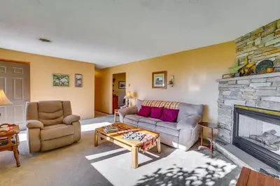 a living room with a couch and a fireplace at Muncy Vacation Rental with Deck and Views in Muncy