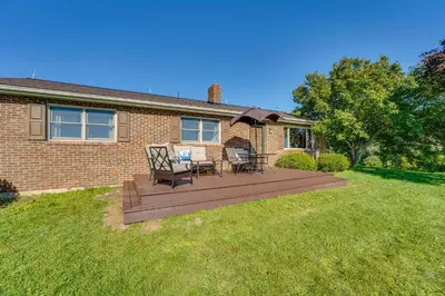 a house with a wooden deck in the yard at Muncy Vacation Rental with Deck and Views in Muncy