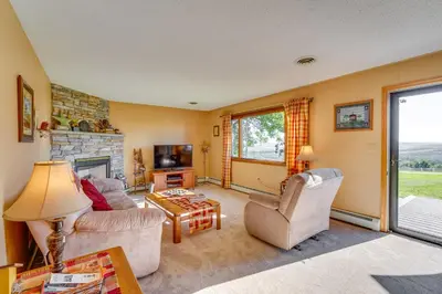 a living room with a couch and a fireplace at Muncy Vacation Rental with Deck and Views in Muncy