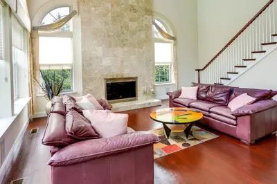 a living room with two couches and a fireplace at Centrally Located Family Home with Pool in Harleysville