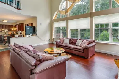 a living room with two couches and a table at Centrally Located Family Home with Pool in Harleysville