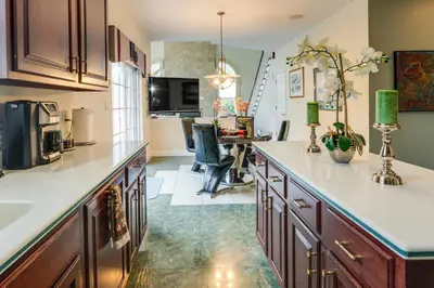a kitchen with wooden cabinets and a counter top at Centrally Located Family Home with Pool in Harleysville