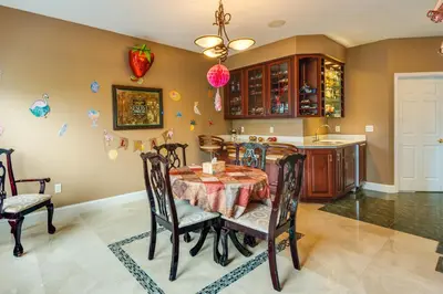 a dining room with a table and chairs and a kitchen at Centrally Located Family Home with Pool in Harleysville