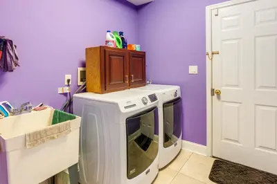 a kitchen with a white stove and a purple wall at Centrally Located Family Home with Pool in Harleysville