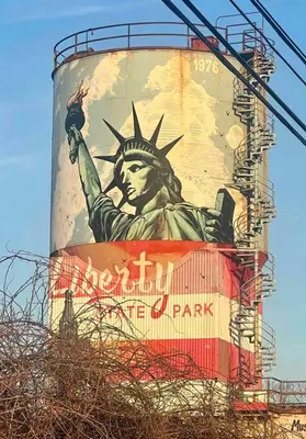 a water tower with the statue of liberty painted on it at 2 Bedroom Apartment, Close to NYC & Downtown JC! in Jersey City