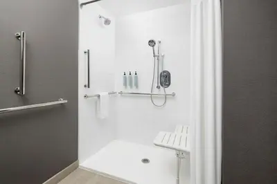 a bathroom with a shower with a shower curtain at Courtyard by Marriott New Castle in New Castle