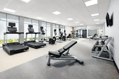 a gym with treadmills and elliptical machines at Courtyard by Marriott New Castle in New Castle