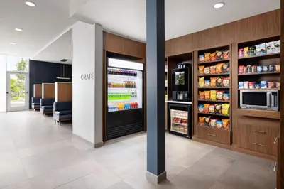 a restaurant with a refrigerator with food in it at Courtyard by Marriott New Castle in New Castle