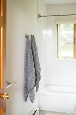 a bathroom with two gray towels hanging on a door at Campbell Estates in Franklin