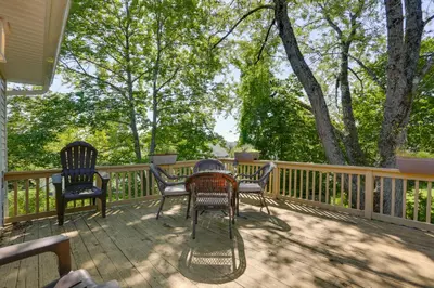 a deck with chairs and a table on it at Kiamesha Lake Home with Deck 4 Mi to Resorts World! in Monticello
