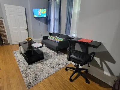 a living room with a couch and a chair at A Victorian home in Philadelphia