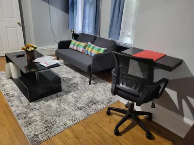 a living room with a couch and a chair at A Victorian home in Philadelphia