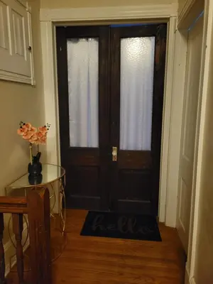 a room with a door with a table and a table sidx sidx at A Victorian home in Philadelphia