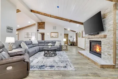 a living room with a couch and a fireplace at Whiskey Pines Retreat! Single Level Home, Outdoor Firepit, AC, BBQ! Sleeps 9 in Lake Harmony! in Lake Harmony