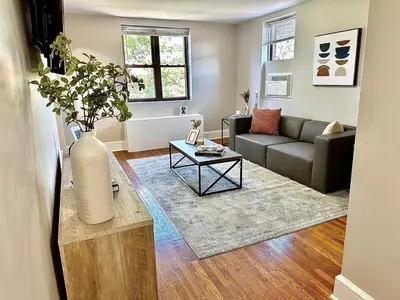 a living room with a couch and a vase on a table at Lennox C402 Peaceful & Perfect Private 1-Br in Philadelphia