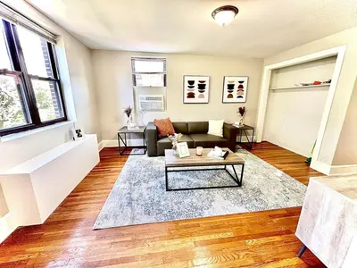 a living room with a couch and a table at Lennox C402 Peaceful & Perfect Private 1-Br in Philadelphia
