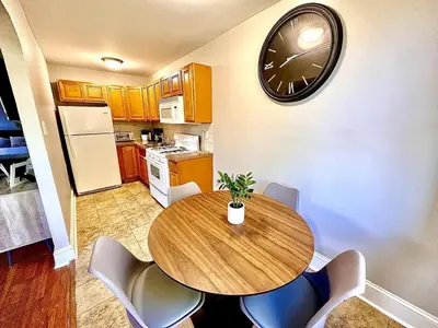 a kitchen with a table and a clock on the wall at Lennox C402 Peaceful & Perfect Private 1-Br in Philadelphia
