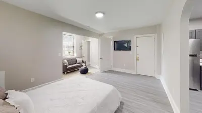 a white bedroom with a bed and a couch at Lennox C101 Perfect & Peaceful Studio Apt in Philadelphia