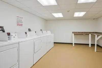 a room with a row of white washing machines at Lennox C101 Perfect & Peaceful Studio Apt in Philadelphia