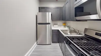 a kitchen with a stainless steel refrigerator and a sink at Lennox C101 Perfect & Peaceful Studio Apt in Philadelphia
